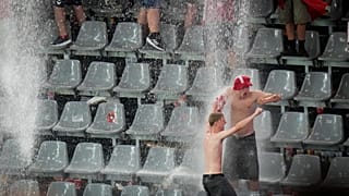 Fans dance in the rain