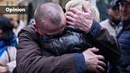 A soldier returning from Russian captivity hugs his wife during a POW exchange between Russia and Ukraine in Chernyhiv region, Ukraine, Thursday, Oct. 2, 2025
