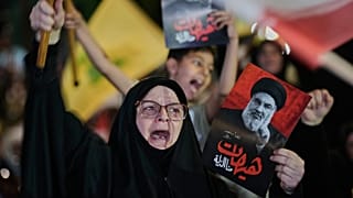 أحد أنصار حزب الله يردد شعارات وهو يحمل صورة زعيم حزب الله الراحل السيد حسن نصر الله خلال تجمع ضد العملية العسكرية الأمريكية الإسرائيلية مع إيران وحلفائها في الضاحية بلبنان