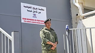 جندي ليبي يقف في حالة تأهب خلال مظاهرة أمام مكتب المفوضية السامية للأمم المتحدة لشؤون اللاجئين في طرابلس، ليبيا