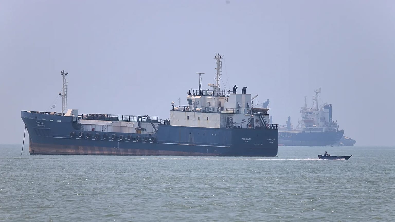A small motorboat passes anchored vessels in the Strait of Hormuz off Bandar Abbas, Iran, Wednesday, June 17, 2026.