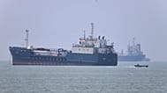 A small motorboat passes anchored vessels in the Strait of Hormuz off Bandar Abbas, Iran, Wednesday, June 17, 2026.