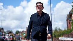 FILE - Andy Burnham smiles during a campaign visit to Ashton-in-Makerfield before the forthcoming by-election, in Manchester, England