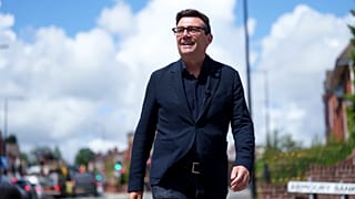 FILE - Andy Burnham smiles during a campaign visit to Ashton-in-Makerfield before the forthcoming by-election, in Manchester, England