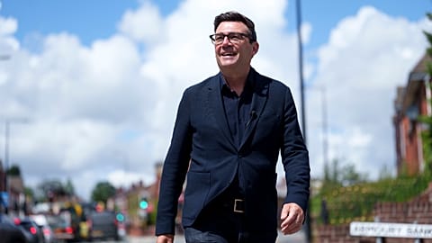 FILE - Andy Burnham smiles during a campaign visit to Ashton-in-Makerfield before the forthcoming by-election, in Manchester, England