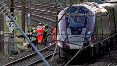Emergency personnel work on a train on the tracks outside Bedford, England, after a train from Corby to London St. Pancras and another from Nottingham to London St. Pancras.