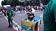 A dog named Osito wears a Mexico national team jersey and rides in a bicycle basket of Jorge Rangel 