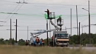 Municipal workers install anti drone nets to prevent Russian attacks on people and transport in Zaporizhzhia, Ukraine, Thursday, June 18, 2026.