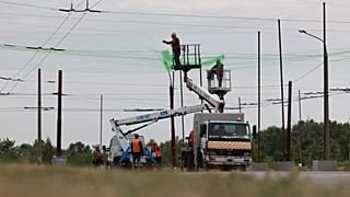 Municipal workers install anti drone nets to prevent Russian attacks on people and transport in Zaporizhzhia, Ukraine, Thursday, June 18, 2026.