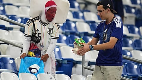 Fans collect trash after the World Cup Group F soccer match between Tunisia and Japan in Guadalupe