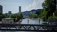 A man dives in the Limmat river during a heat wave in Zurich, Switzerland, Friday, June 19, 2026.