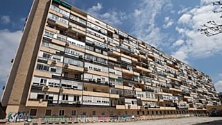 FILE - In this April 8, 2020 file photo, a man walks in front of a large apartment block in Madrid, Spain. 5 October 2021.