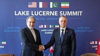 Iran’s Foreign Minister Abbas Araghchi and Swiss counterpart Ignazio Cassis shake hands at bilateral discussions near Lucerne, Switzerland, Sunday, June 21, 2026