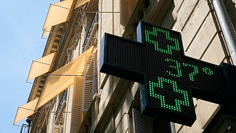 A sign outside a pharmacy displays a temperature of 37 degrees Celsius (98.6 degrees Fahrenheit) in Paris, Sunday, June 21, 2026. 