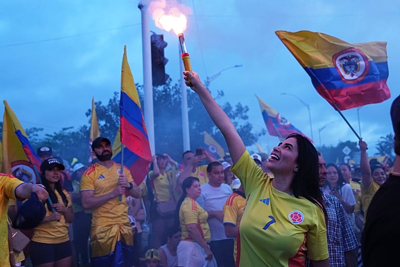 A supporter of presidential candidate Abelardo de la Espriella light a flare at a celebration rally after polls closed in Barranquilla, Colombia, Sunday, June 21, 2026. 