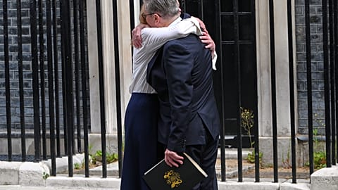 Britain's Prime Minister Keir Starmer hugs his wife Victoria after he announced his resignation outside 10 Downing Street in London, Monday, June 22, 2026