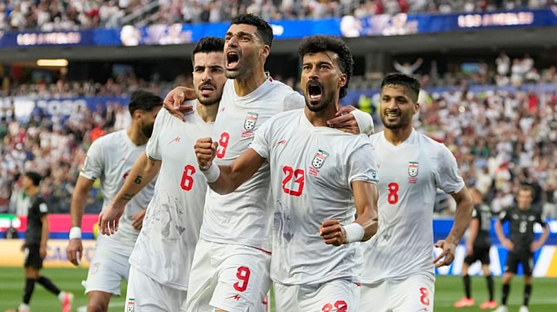 Iran's Ramin Rezaeian (23) celebrates with his teammates after scoring a goal during