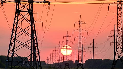 Power lines in front of a sunset.