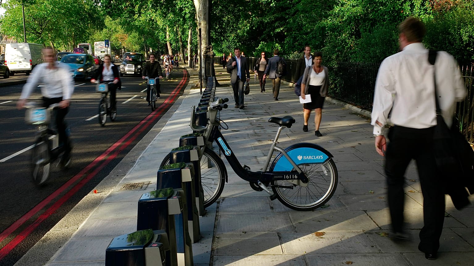 Cyclists and pedestrians walk past a lone hire cycle amongst the empty racks on the Embankment in London, Tuesday, Sept. 7, 2010. 