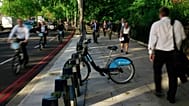 Cyclists and pedestrians walk past a lone hire cycle amongst the empty racks on the Embankment in London, Tuesday, Sept. 7, 2010. 