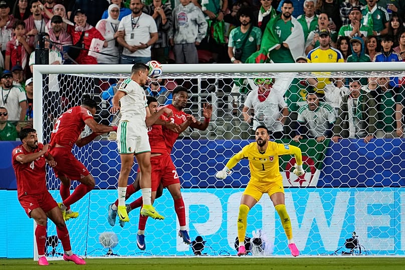 Algeria's Nadhir Benbouali heads the ball to score his side's opening goal during the World Cup Group J match against Jordan, near San Francisco, Monday, June 22, 2026