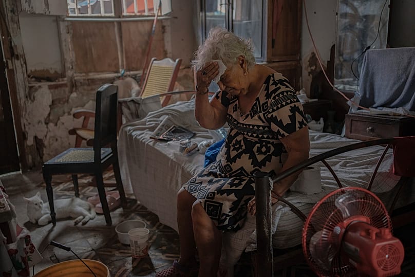 FILE - Margarita Salazar, 82, wipes the sweat off with a tissue inside her home amid hot weather in Veracruz, Mexico, on June 16, 2024. 
