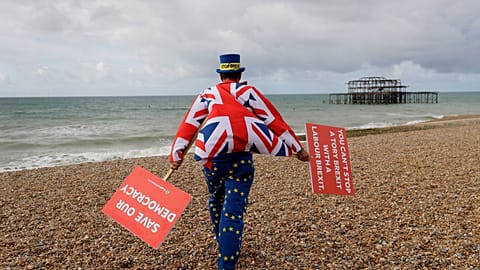 FILE. Anti Brexit campaigner Steve Bray walks on the beach to pose for a photograph during the Labour Party Conference at the Brighton Centre, England, Sept. 2019