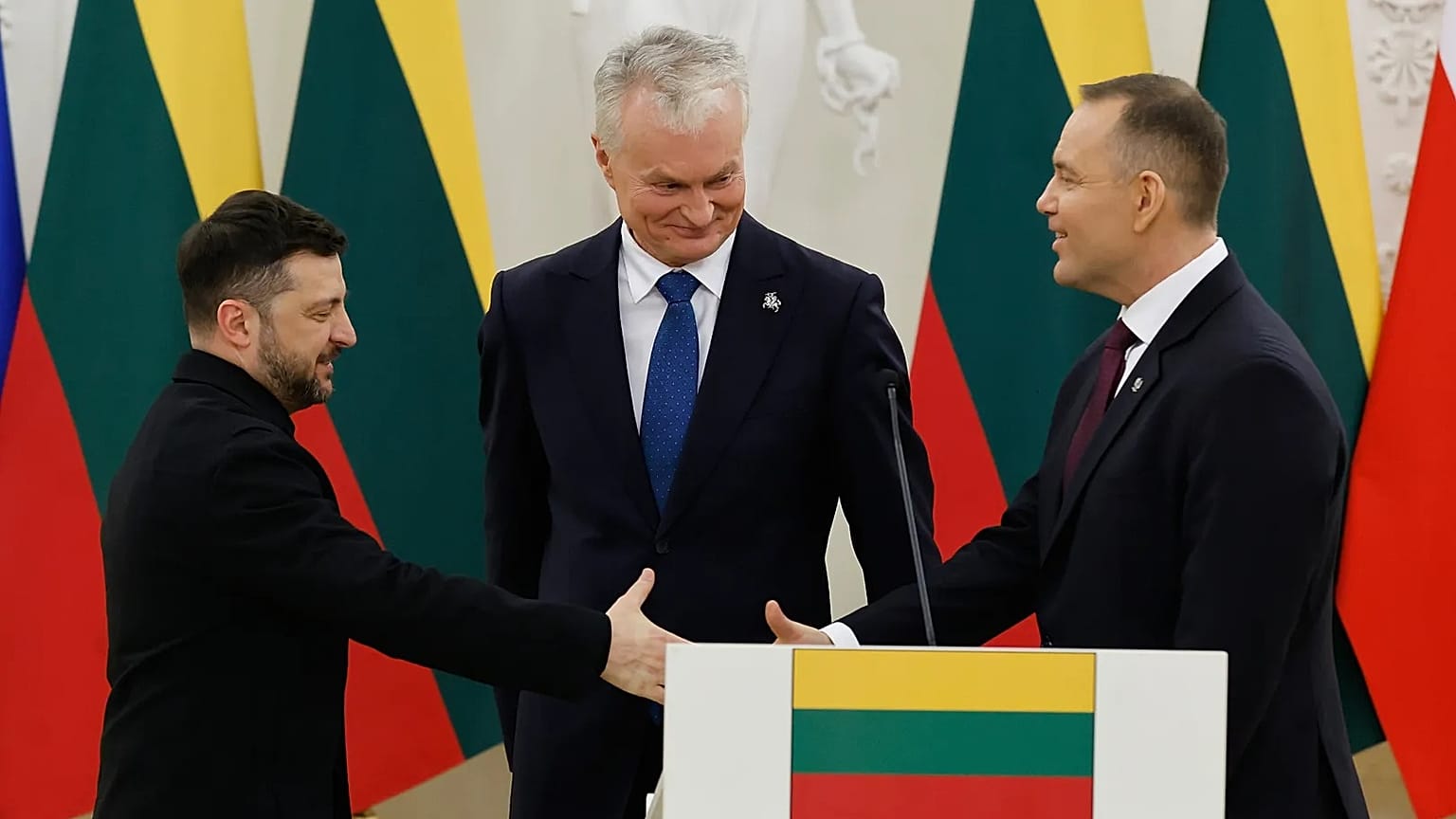 Prezydent Ukrainy Wołodymyr Zełenski i prezydent Polski Karol Nawrocki podają sobie ręce, w towarzystwie prezydenta Litwy Gitanasa Nausedy, WIlno 25 stycznia, 2026 r. 