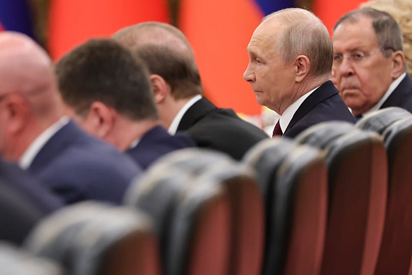 Russian President Vladimir Putin, second right, alongside Foreign Minister Sergei Lavrov, in Beijing 20 May, 2026.