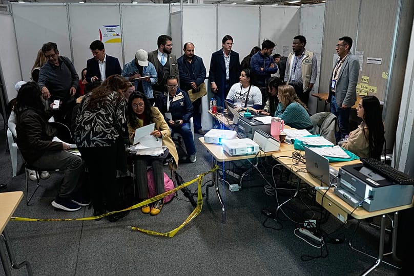 Trabajadores electorales, observadores y delegados asisten al recuento de votos al día siguiente de la segunda vuelta en Bogotá, el lunes 22 de junio de 2026. 