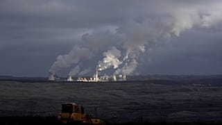 Steam and smoke rise from power plant located by the Turow lignite coal mine near the town of Bogatynia, Poland.