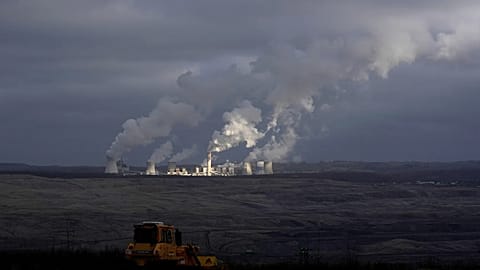 Steam and smoke rise from power plant located by the Turow lignite coal mine near the town of Bogatynia, Poland.