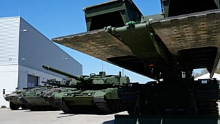 An armoured personnel carrier, a Puma infantry fighting vehicle and a Leopard battle tank produced by pan-European defense company KNDS are displayed in Munich, 22 April 2026