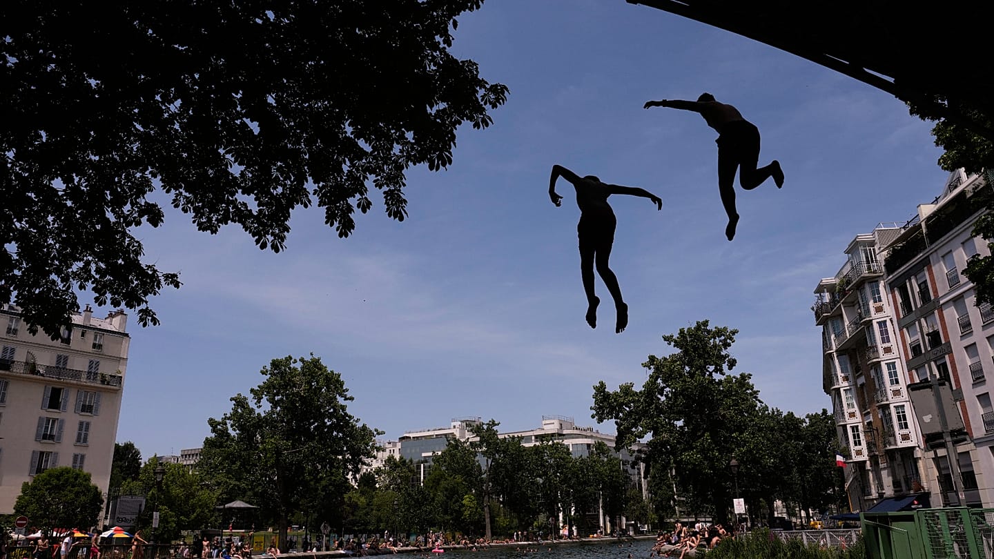 Red heatwave alerts spread across Europe with hottest day ever in France and 40 deaths from drowning