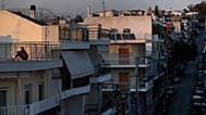 Εικόνα αρχείου- A woman sits on a rooftop in Athens, Saturday, March 21, 2020