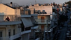 Εικόνα αρχείου- A woman sits on a rooftop in Athens, Saturday, March 21, 2020
