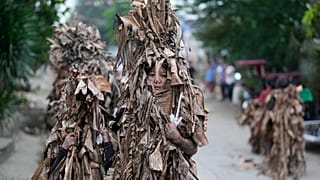 Catholic devotees covered in mud and banana leaves take part in the Mud People festival in Bibiclat, Nueva Ecija, Philippines, on June 24, 2026.