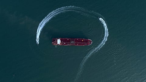 FILE: A speedboat of Iran's Revolutionary Guard circling the British-flagged tanker Stena Impero in the Strait of Hormuz in July 2019.