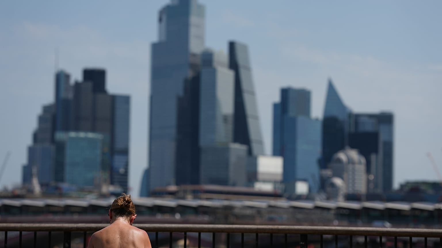 A woman sunbathes in London, as a heatwave is predicted Tuesday, June 23, 2026.