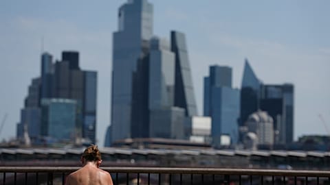 A woman sunbathes in London, as a heatwave is predicted Tuesday, June 23, 2026.
