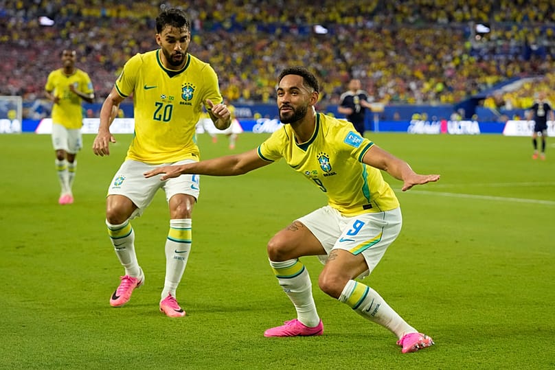 Brazil's Matheus Cunha celebrates with Lucas Paqueta after scoring the third goal during the World Cup Group C match against Scotland in Miami, Wednesday, June 24, 2026