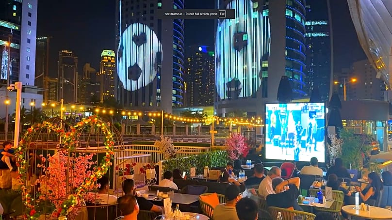 Football fans watch Qatar's final Group B match against Bosnia and Herzegovina at a cafe in Doha.