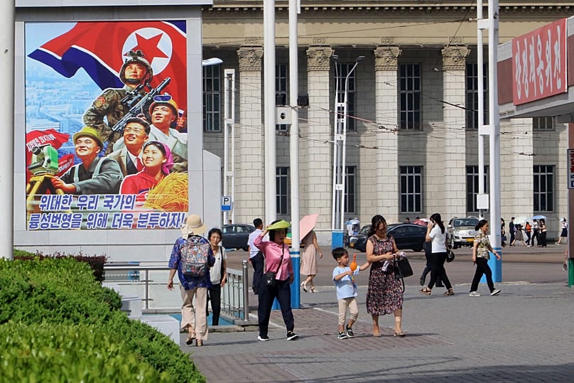 People walk in the street of the Central District in Pyongyang, North Korea, Monday, June 22, 2026.
