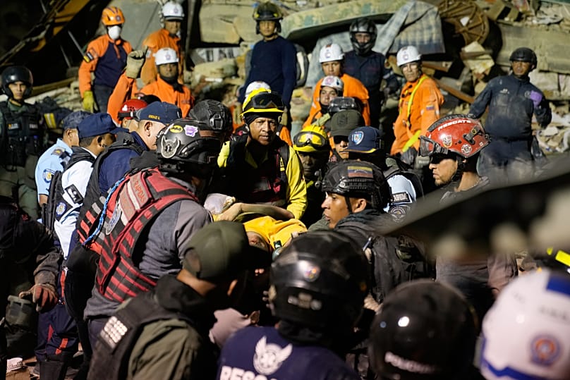 Rescue workers search through the rubble of a collapsed building after earthquake in Caracas, Venezuela, Wednesday, June 24, 2026.