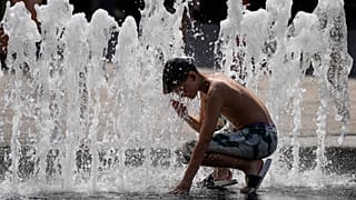 A boy cools off in a fountain at the city centre of Budapest, Hungary, during a heatwave with 35 degrees Celsius on Saturday, Aug. 26, 2023.