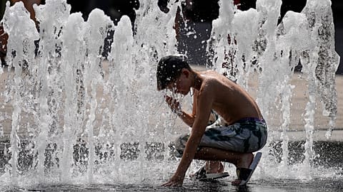 A boy cools off in a fountain at the city centre of Budapest, Hungary, during a heatwave with 35 degrees Celsius on Saturday, Aug. 26, 2023.