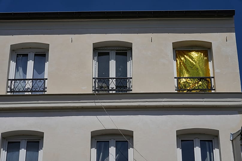 A thermal blanket covers a window to help keep out the heat during a heatwave in Saint-Germain-en-Laye, west of Paris, Thursday, June 25, 2026. 