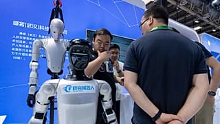 Workers prepare robots at the China International Supply Chain Expo in Beijing on Monday, June 22, 2026.