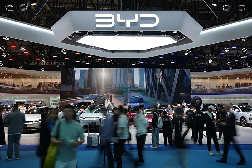 Visitors tour Chinese automaker BYD booth with a screen showing its battery charging station under sub-zero temperatures technologies - Auto China 2026, Beijing, April 2026.