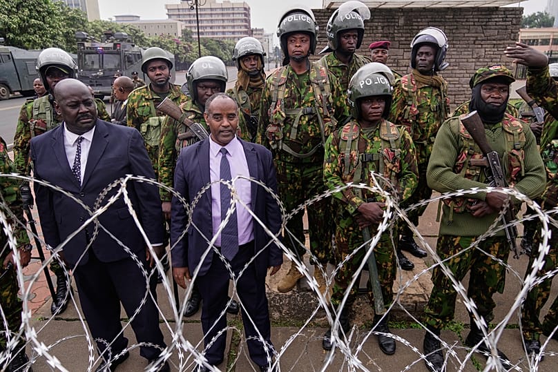 Police stand guard around parliament during a demonstration to mark two years since more than 60 people died in anti-government protests, Nairobi, Kenya, June 25, 2026